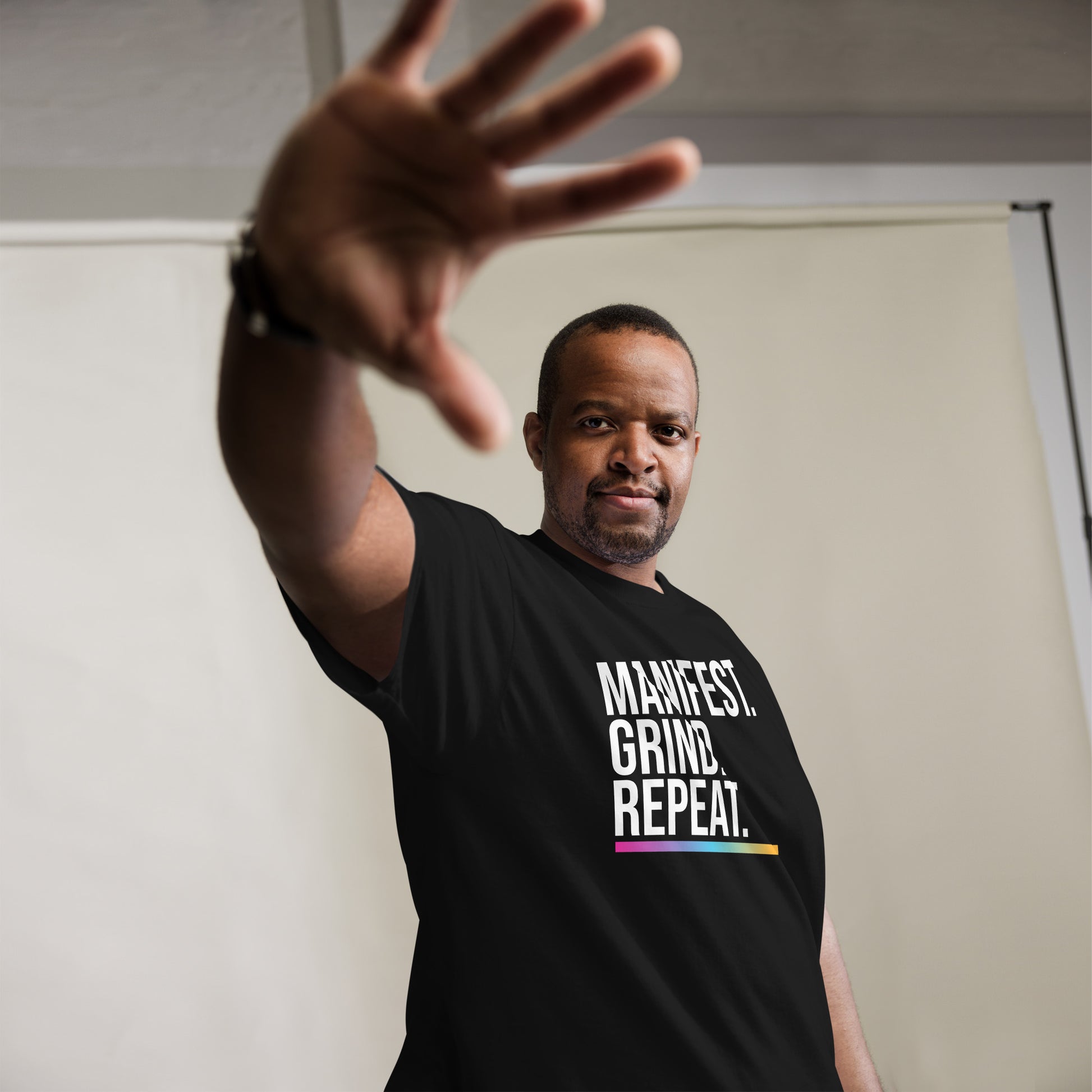 Unisex entrepreneurial t-shirt with ‘Manifest. Grind. Repeat.’ motivational design — WYVibe premium tee.
